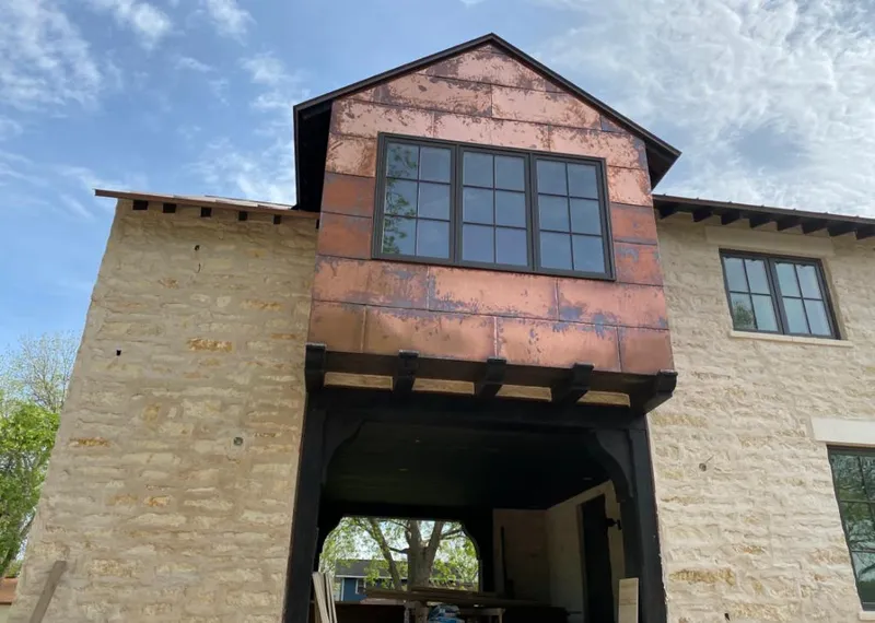 Copper metal panel facade on a stone building for Roof Repair in Cudahy